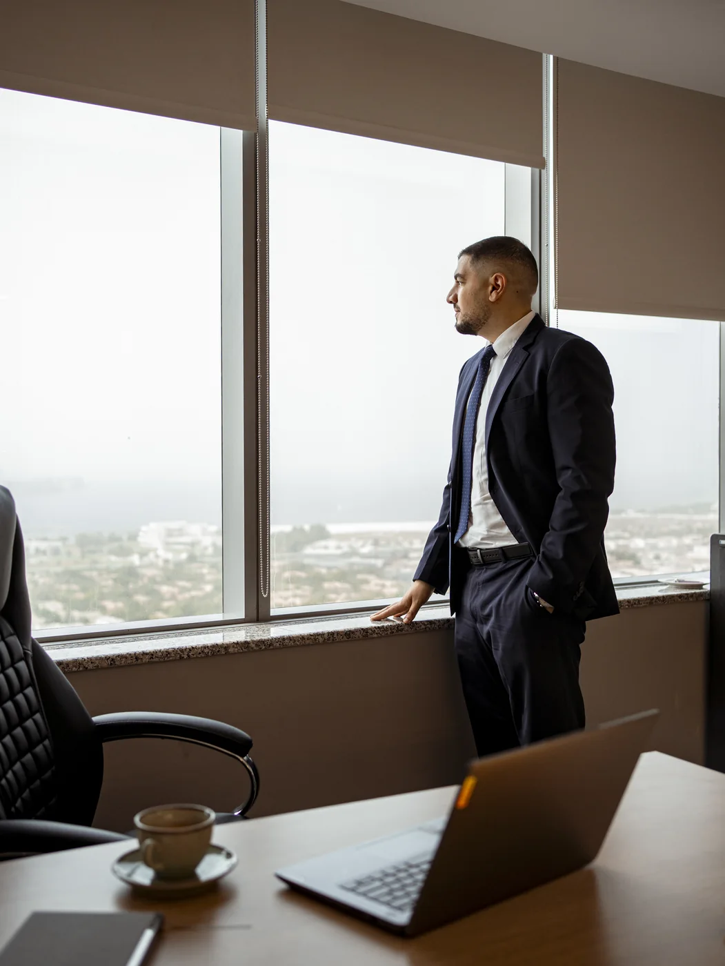 Ahmed El-Sayad overlooking Dubai skyline from private advisory office